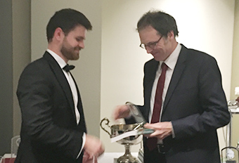 Damian Page presenting a copy of Sawer’s The Australian Constitution to one of the winners